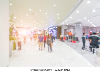 Abstract blur beautiful modern luxury shopping mall and retails store interior for background. color filter people walking in shopping mall. department store indoor. shopping mall.vacation weekend day