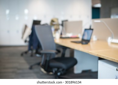 Abstract Blur Business Office Working Space Background With Modern Interior Table And Chair With Devices. Blurry Creative Workplace Design Background