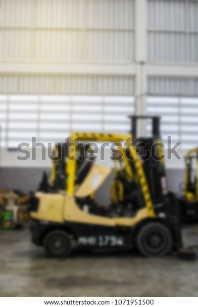 Abstract blur car forklift truck in workshop\
station background.