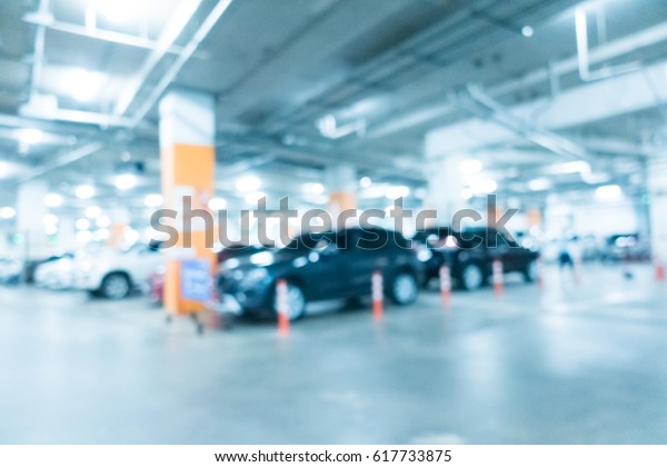 Abstract blur car parking in shopping\
mall for background - Blue white balance\
processing