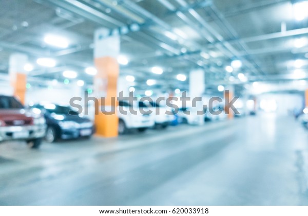 Abstract blur car parking in shopping\
mall for background - Blue white balance\
processing