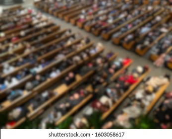 Abstract Blur Of Church Members In Pews From Above Inside Sanctuary.