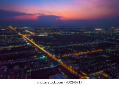 Abstract Blur City Top View Of City Scene At The Night View From Airplane Window.