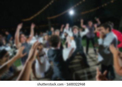 Abstract Blur Of College Kids Partying Outdoors To Music. 