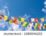 Abstract blur of colorful flags with vivid color use as tailsman for safety travel in tibetan on blue sky background