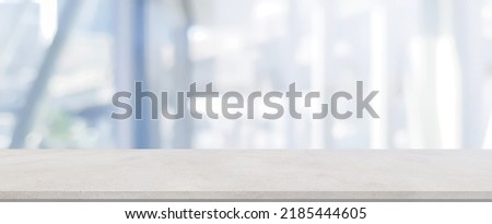 abstract blur contemporary interior living room in blue color background with white cement table for show, promote and design content or product on display concept