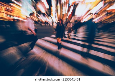 Abstract Blur crowd of anonymous people hurry and rush to cross the street at Shibuya zebra pedestrian crossing or scramble crosswalk during evening rush hour. Urban lifestyle and rushing concept.