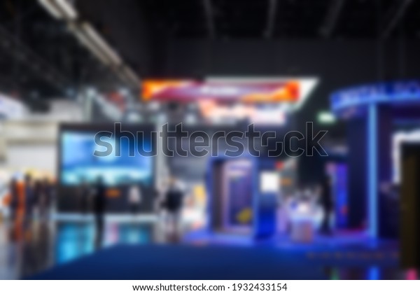 Abstract of blur crowd and lights in exhibition\
hall background of department shopping mall, Blurred soft of people\
in business office walking through building, technology market expo\
exhibition event