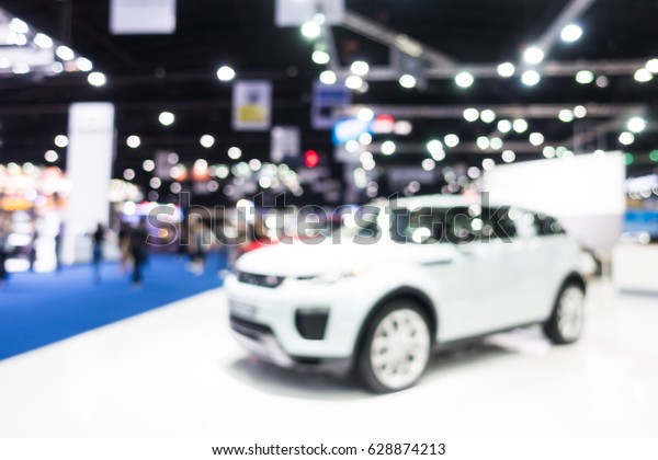 Abstract blur and defocused car and motor\
exhibition show interior for\
background