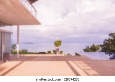 Abstract blur of external deck of high end villa view to the sea can be used as background