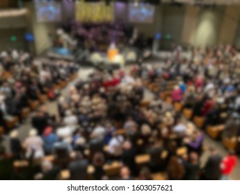 Abstract Blur Of A Full Mega Church Indoors.