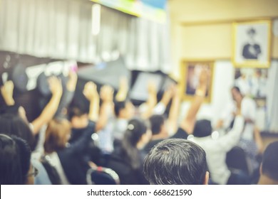 Abstract blur of Group of young Audience sitting on conference together while all raising hand. Diversity Casual Team Cheerful Community Concept. Copy space
