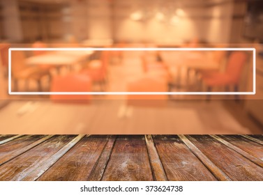 Abstract blur image of empty restaurant with wood table and chairs for background usage.(vintage tone)