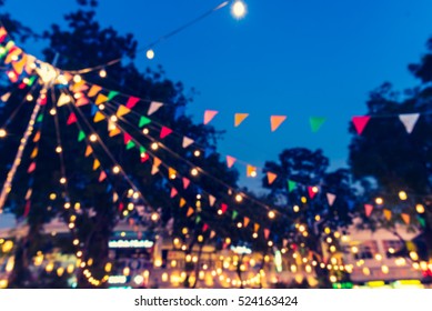 Abstract Blur Image Of Food Stall At Night Market Festival For Background Usage . (vintage Tone)