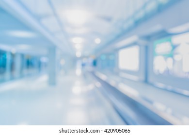 Abstract Blur Image Of Long Corridor In Subway With People For Background Usage .