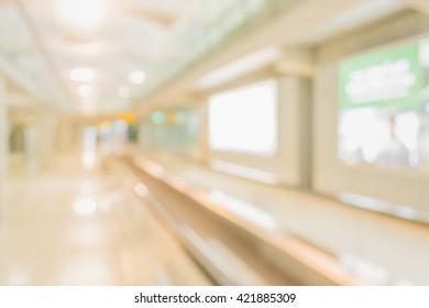 Abstract Blur Image Of Long Corridor In Subway With People For Background Usage .