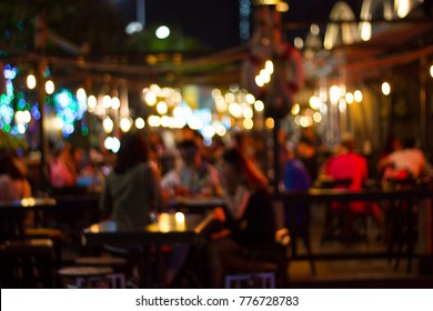abstract blur image of night festival in a restaurant and The atmosphere is happy and relaxing with bokeh for background
