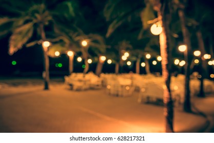 Abstract blur image of  Outdoor Cafe or restaurant  in night time with bokeh for background usage . (vintage tone)