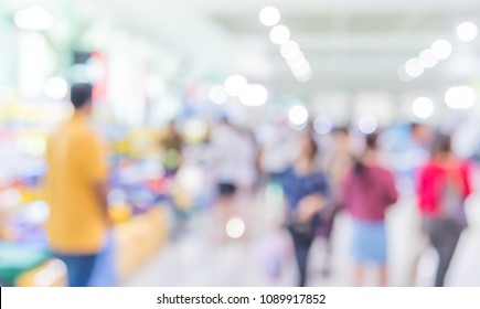 Abstract Blur Image Of People Walking At Shopping Mall Or Exhibition Hall With Bokeh For Background Usage .