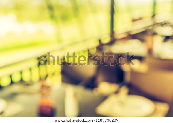 Abstract blur image of\
Restaurant or Cafe on day time with bokeh for background usage .\
(vintage tone)