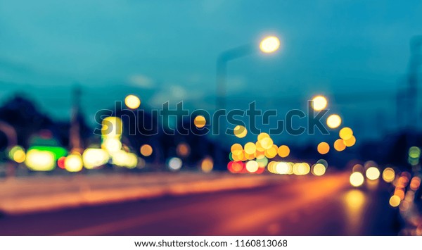 Abstract blur image of Road in\
evening time  with light bokeh for background usage . (vintage\
tone)