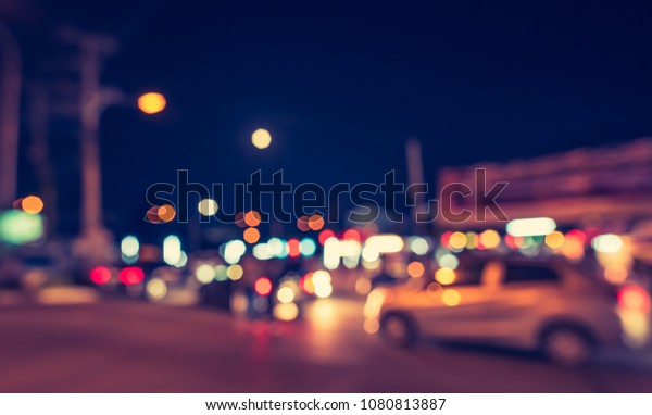 Abstract blur image of  Road in Night time
with bokeh for background usage . (vintage
tone)