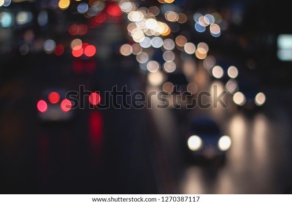 Abstract blur image of Road in Night time\
with bokeh for background usage blurred background. Night city\
lights blur. Retro toned photo, vintage\
tone.