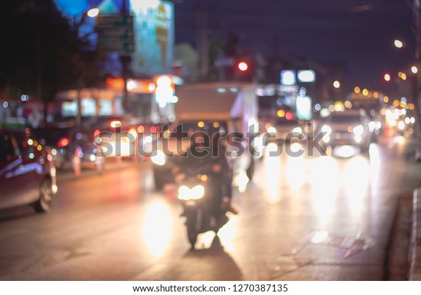 Abstract blur image of Road in Night time\
with bokeh for background usage blurred background. Night city\
lights blur. Retro toned photo, vintage\
tone.