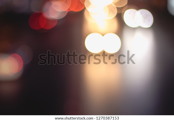 Abstract blur image of Road in Night time
with bokeh for background usage blurred background. Night city
lights blur. Retro toned photo, vintage
tone.