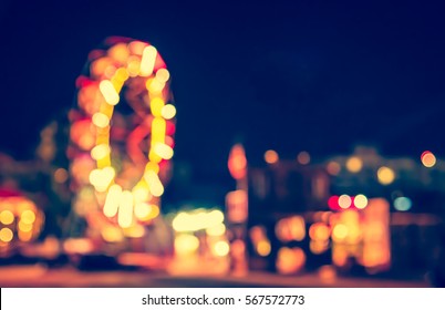 Abstract Blur Image Of Theme Park On Night Time For Background Usage .(vintage Tone)