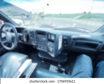 Abstract Blur Of Interior Of A Delivery Truck, Dashboard And Windshield Background. 