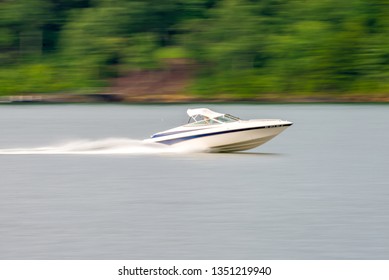 Abstract Blur Of Nature And Fast Moving Boat On Lake