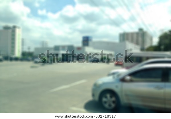 Abstract blur outdoor car parking at\
supermarket, blur car parking background, outdoor car parking\
blurred background