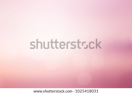 abstract blur of pastel beautiful sunrise pink color sky warm tone background with shining light flare and bokeh for design as banner,slide show or others 