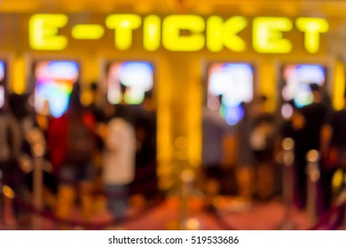 Abstract Blur People Buying Movie Ticket From E-ticket Selling Machine In Front Of The Theater