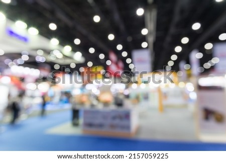 Abstract blur people in exhibition hall event trade show expo background. Large international exhibition, convention center, Business marketing and MICE industry concept.