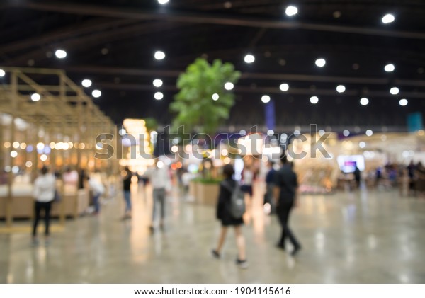 Abstract blur\
people in exhibition hall event trade show expo background. Large\
international exhibition, convention center, business marketing and\
event fair organizer\
concept.