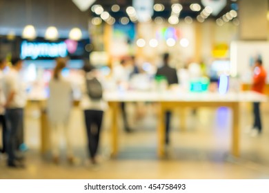 Abstract Blur People Shopping In Gadget Retail Store Selling Smart Phone, Tablet Pc, Touch Pad And More.