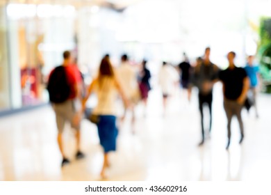 Abstract Blur People Walking In Fashion Mall. The Light Come Straight From Front Door.