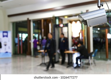 Abstract Blur People Walking Through Metal Detector In A Building Background.