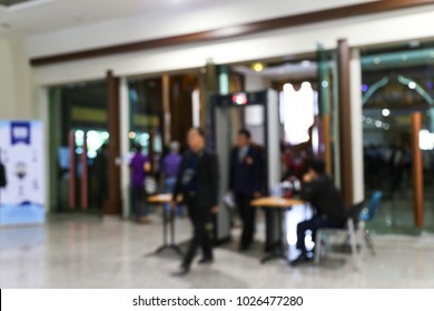 Abstract Blur People Walking Through Metal Detector In A Building Background.