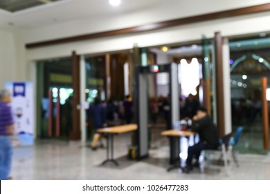 Abstract Blur People Walking Through Metal Detector In A Building Background.