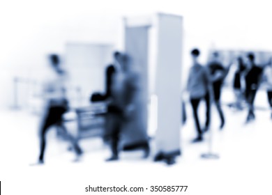 Abstract Blur People Walking Through Security Gate Entering Building In Black And White