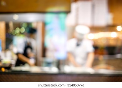 Abstract Blur Of Pizza Or Italian Restaurant With Chef In The Background