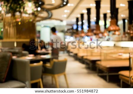 Abstract blur restaurant interior as background. Waiter receiving food order from customers.
