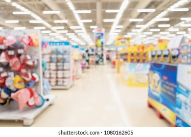 Abstract Blur Supermarket Aisle Interior Background With Baby Formula Milk Product And Clothing On Shelves