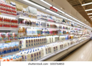 Abstract Blur Supermarket Grocery Store Refrigerator Shelves With Fresh Milk Bottles And Dairy Products