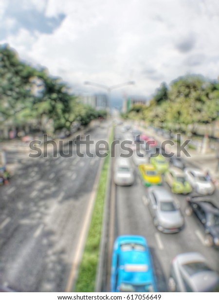 Abstract blur of\
traffic jam in the evening backgrounds :  blur of vehicles cars,\
saloon, bus, motorcycle, people at the road : out of focus concept\
in the city Bangkok Thailand\
