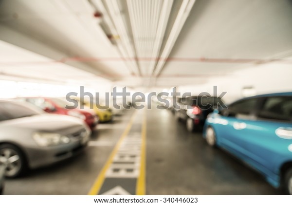 Abstract blur urban outdoor car\
park space management in modern shopping mall, company, office, or\
manufacture as a blurry background. forecourt parking\
area