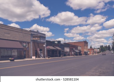 Abstract Blur Vintage Tone Image Of Blurred Typical Small Town Main Street In The United States Of America.